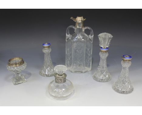 An Edwardian silver mounted cut glass decanter of hexagonal flask form with two handles, each side cut with a flowering stem,