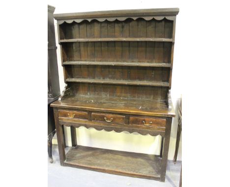 A 20th century Jacobean style oak dresser, the shelf back above three drawers and an open base, on block legs, height 195cm, 