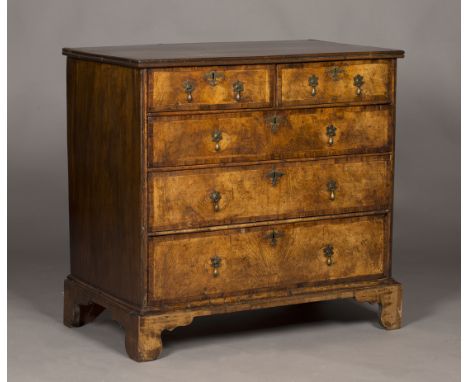 A George I walnut chest of two short and three long drawers, the drawer fronts with crossbanded borders, raised on bracket fe