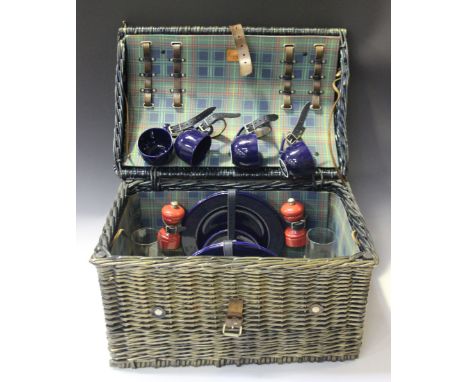 A late 20th century wicker picnic hamper, retailed by Asprey, the fitted interior lined in blue checked fabric, width 49cm.