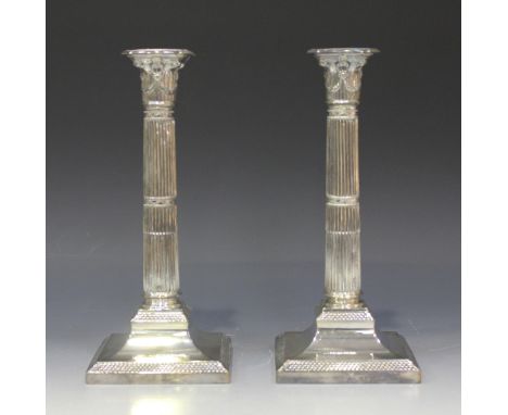 A pair of late Victorian silver Corinthian column candlesticks, each on a square base with fish scale decoration, Sheffield 1