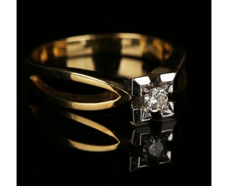 A gold and diamond single stone ring, mounted with a circular cut diamond within a square shaped setting between pierced open