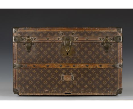 A late 19th/early 20th century Louis Vuitton travelling trunk with overall monogram and quatrefoil decoration on a brown grou