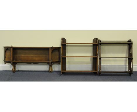 A late Victorian walnut three-tier wall shelf, width 61cm, together with two other similar wall shelves.