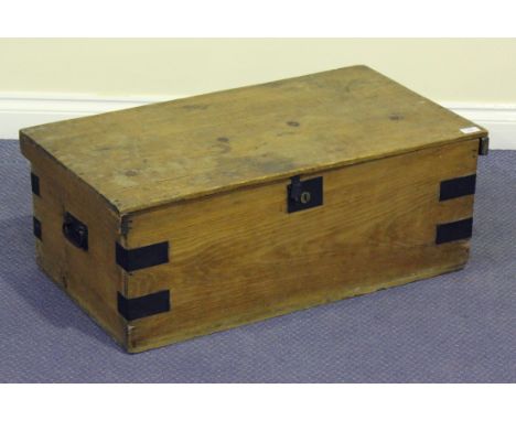 A 19th century pine trunk with swing handles and metal bound corners, height 30cm, width 81cm, depth 44cm.