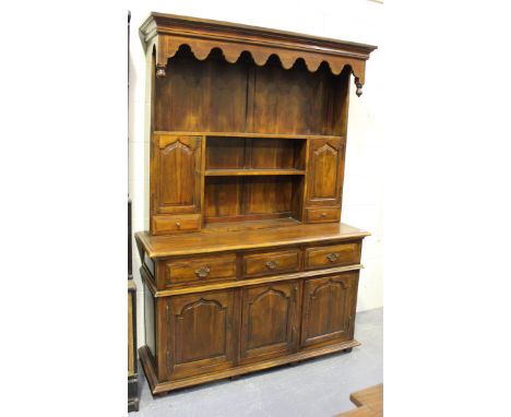 A modern hardwood dresser, the shelf back above drawers and cupboards, on block feet, height 202cm, width 141cm, depth 46cm.