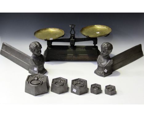 A pair of late 19th century cast iron fire chenets with child head finials, height 20cm, together with a set of balance scale