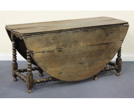 An 18th century and later fruitwood oval gateleg dining table with bobbin turned and block legs, height 72cm, width 152cm (al