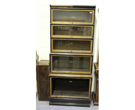 An early 20th century oak and ebonized five-section Globe Wernicke glazed bookcase, raised on a shaped plinth base, height 20