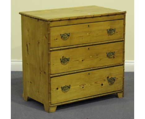 A 19th century stripped pine chest, fitted with three dummy drawers opposing an open back with a cupboard door and three smal