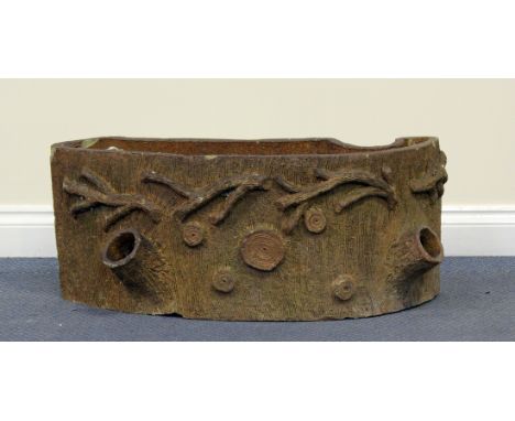 An early 20th century red stoneware 'faux bois' garden planter, modelled in the form of a naturalistic tree stump, height 32c