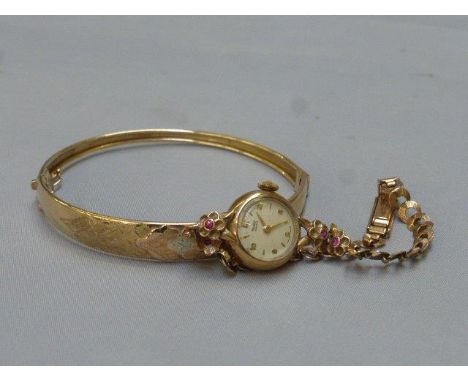 A 9ct gold Rotary Maximus ladies wristwatch and 9ct gold strap and a gold bangle marked 9ct Italy.