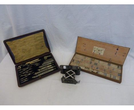 A cased Halden geometry set, a Piccalette camera and a universal solid rubber type printing set.