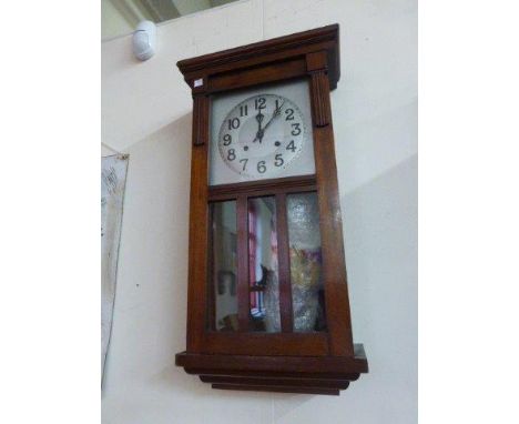 An Art Deco oak-cased wall clock with silvered dial