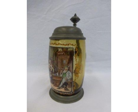 A pewter lidded and amber glass tankard with hand-painted panel depicting a card game in a tavern.