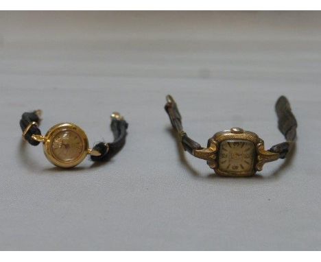 A ladies gold Omega wristwatch with engine turned decoration to the back, the winder is mounted to the back and a ladies earl