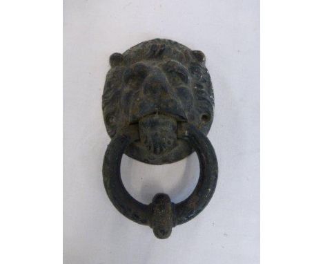 A Victorian cast metal lion's head door knocker.