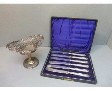 A cased set of six silver-handled butter knives, maker WY Sheffield 1919 and a silver-plated pedestal fretwork basket.