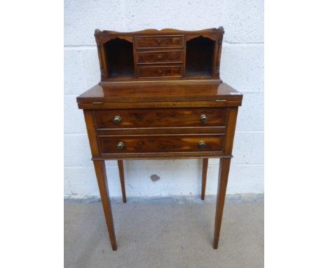 A yew wood ladies writing desk, the upper section comprising a three-quarter gallery shelf above three central drawers flanke