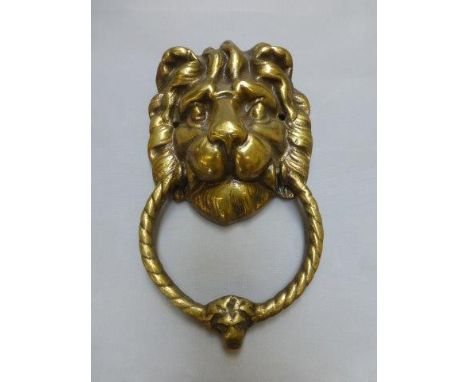A large brass lion head door knocker. 