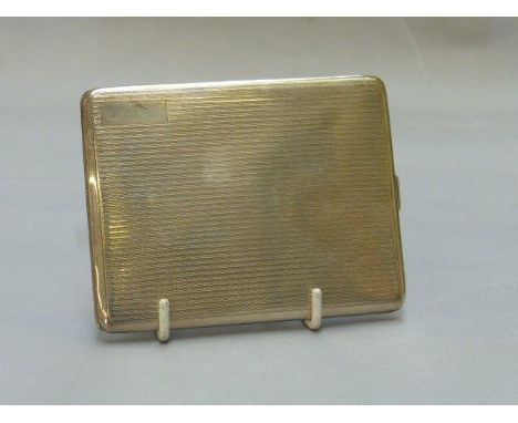 A silver cigarette case with engine turned decoration, maker Adie Brothers, Birmingham 1928.