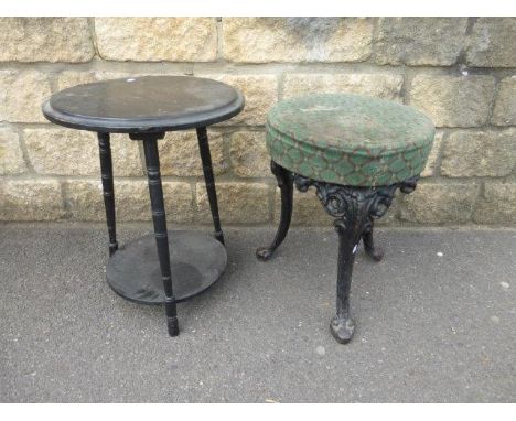 A Victorian cast-iron tripod stool with later top and an Edwardian two-tiered circular occasional table.