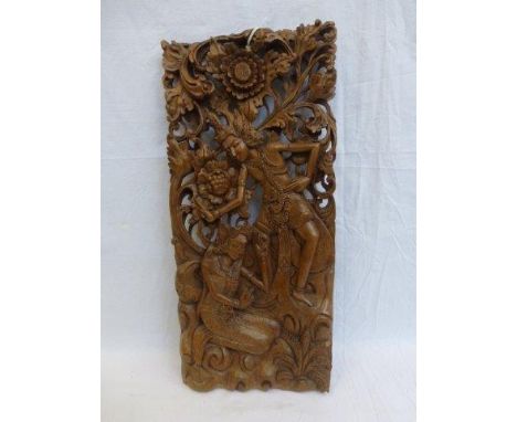 A decorative carved wooden panel depicting dancing figures, possibly Burmere.
