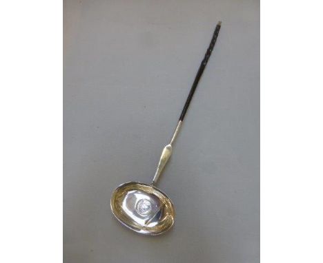 A horn-handled toddy ladle, the bowl inset with a George II shilling to the well.