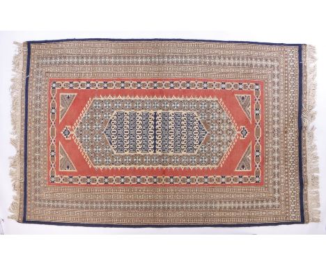 Middle Eastern carpet, the puce ground with scroll decorated lozenge centre surrounded by multiple borders and tasselled ends