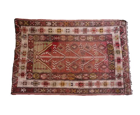 Middle Eastern carpet, the faded red ground surrounded by geometric borders, 104cm x 161cmCarpet has been trimmed to one end,