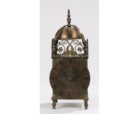 19th Century style brass cased lantern clock, the arched pediment with bell and pierced frieze, the dial with Roman numerals,