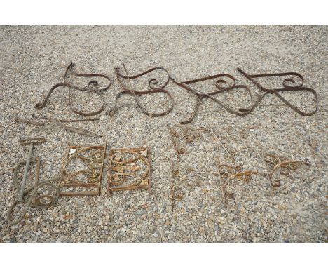 A collection of wrought iron garden items to include bench ends. 
