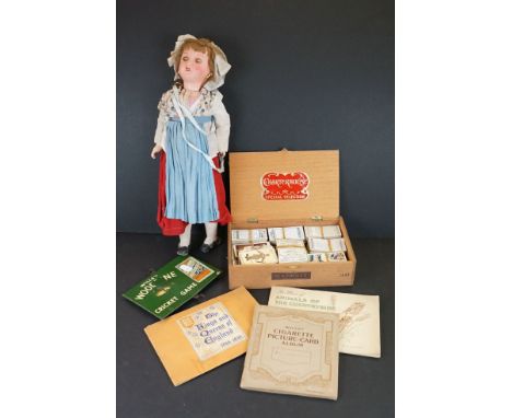 A collection of cigarette cards together with a tin plate Woodbine cricket game and a doll.