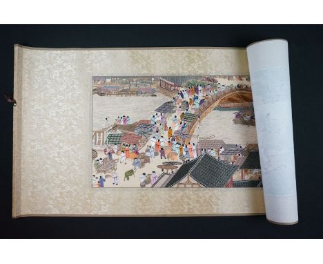 A Chinese embroidered scroll picture depicting a street market scene. 