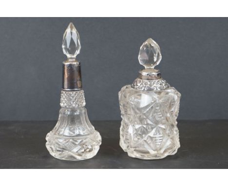 Two cut glass scent bottles with fully hallmarked sterling silver mounts. 