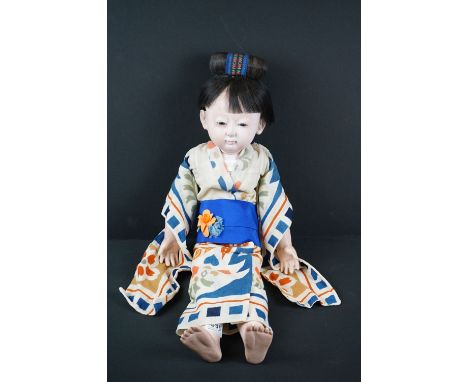 A large Chinese articulated doll in traditional dress, stands approx 60cm in height. 