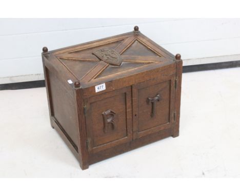 19th century Oak Small Cupboard, the top carved with four carved knops and shield inset with a lion, two panel doors carved w