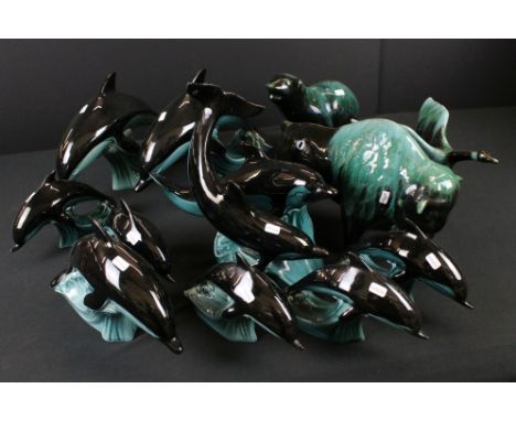 Nine Poole Pottery Leaping Wave Dolphins of various sizes to include a Double Dolphin example together with Three Blue Mounta