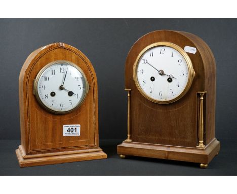 Two early 20th century wooden cased mantle clocks with white enamel dials and chiming movements. 