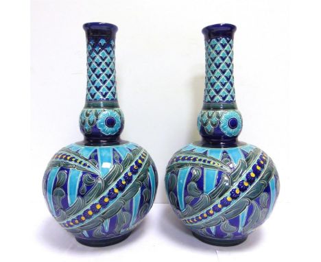A PAIR OF BURMANTOFTS FAIENCE PARTIE-COLOUR PERSIAN VASES designed by Joseph Walmsley, model no. 2061, with stylized floral a