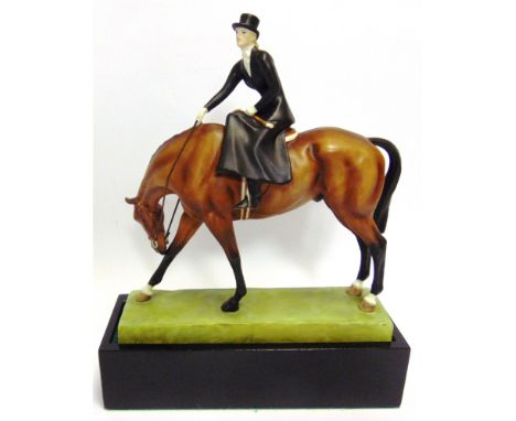 A ROYAL WORCESTER MODEL 'AT THE MEET' by Doris Lindner, No. 3114, depicting a lady riding side saddle on a bay horse, on an e