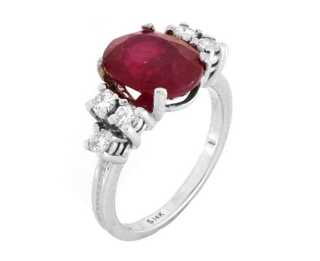 Vintage Oval Cut Ruby, Round Brilliant Cut Diamond and 14 Karat White Gold Ring. Ruby measures 10mm x 8mm. Stamped 14K. Ring 