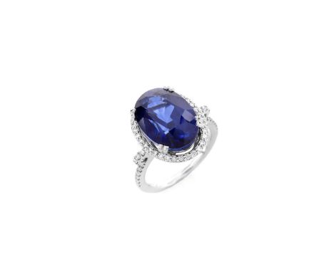 Oval Cut Sapphire, Diamond and 14 Karat White Gold Ring. Sapphire with vivid violet blue color, measures 14mm x 10mm. Stamped