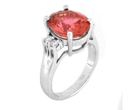 6.60 Carat Oval Cut Orange Sapphire, Diamond and 14 Karat White Gold Ring. Sapphire with vivid color, measures 12mm x 10mm. S
