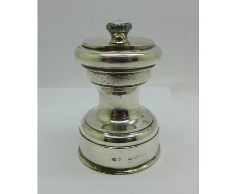 A silver pepper grinder 