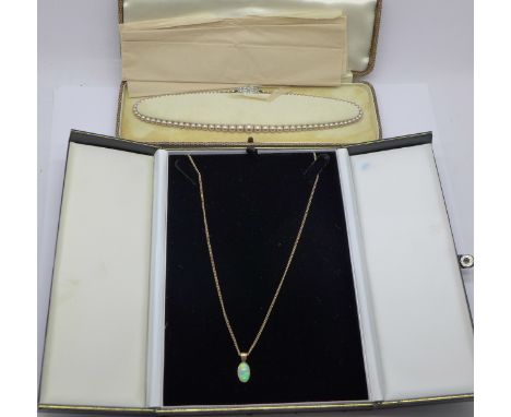 A 9ct gold and opal pendant and chain, 5.1g, stone cracked, and a faux pearl necklace