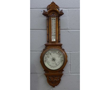 A carved oak Aneroid Barometer, Aitchison &amp; Co., London, a/f 