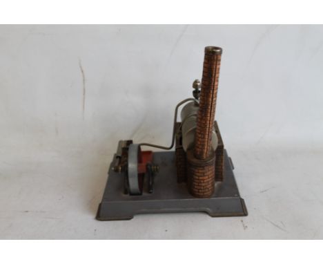 A STATIONARY STEAM ENGINE MODEL, possibly by Wilesco, the casing and chimney in copper with simulated brick surfaces