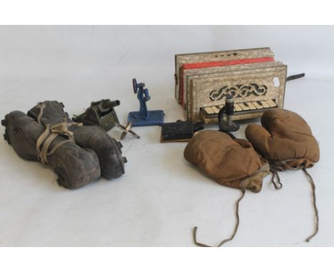 A PAIR OF VINTAGE LEATHER FOOTBALL BOOTS, a pair of child's boxing gloves, a child's accordion, a Britain's Howitzer Garrison