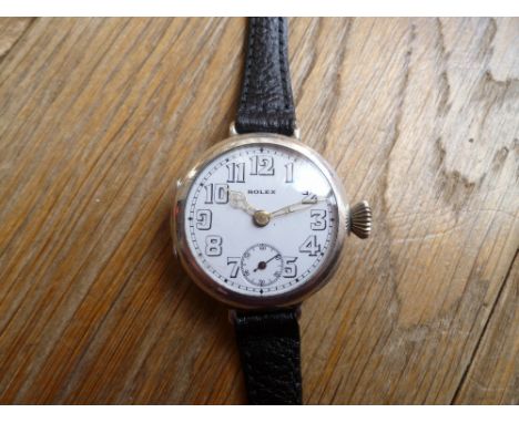 ROLEX, A WWI ERA SILVER TRENCH WATCH, London import marks for 1915, white enamel dial with Arabic numerals, wire lugs, case D